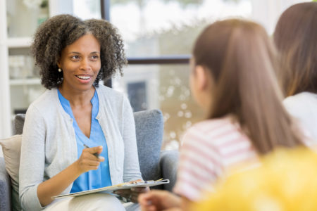 Mental health therapist listening intently to patient in talk therapy session.