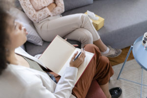 Black female doctor talks with a patient about her depression diagnosis.