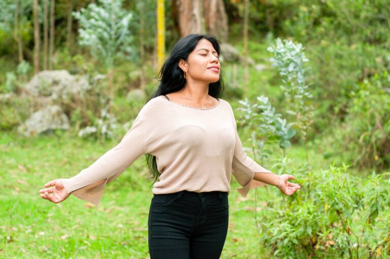 image of a forearm and hand reaching out to touch a moss-covered tree, representing relief from anxiety by connecting with nature.